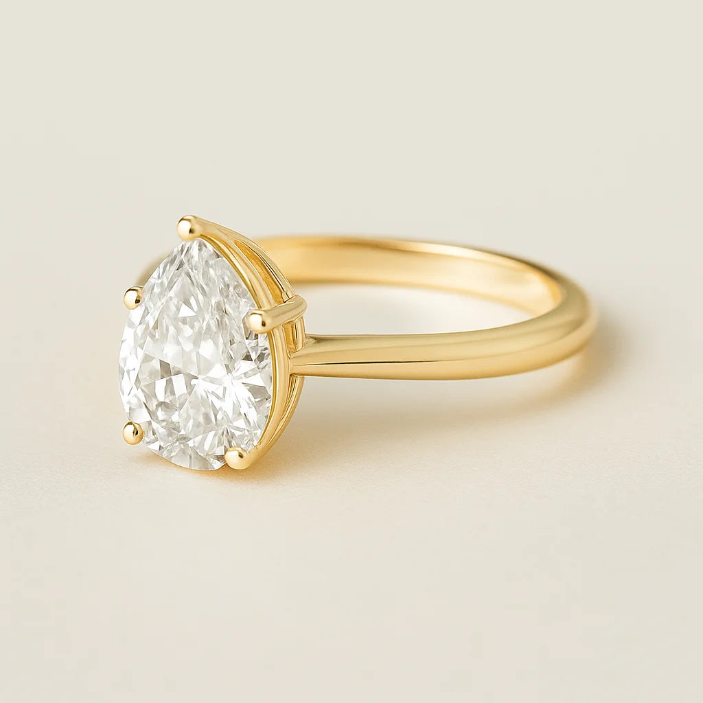 Gold plated ring with a large diamond on a light beige background