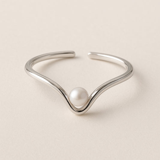 Silver Ring with a pearl on a beige background