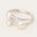 Silver bangle with three pearls on a light background