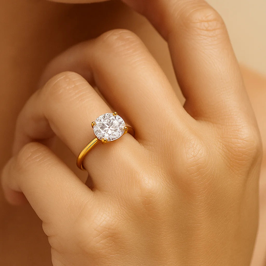 Gold ring with a diamond on a hand against a neutral background
