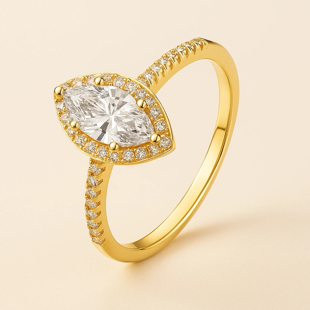 Gold plated ring with a large central gemstone and smaller stones on a beige background