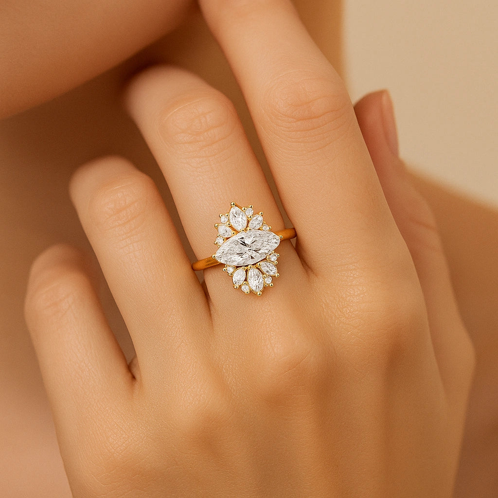 Gold plated ring with a diamond on a hand against a beige background