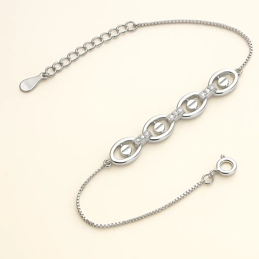 Silver bracelet with interlocking loops on a light beige background