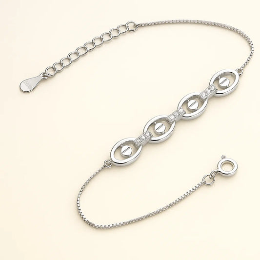 Silver bracelet with interlocking loops on a light beige background
