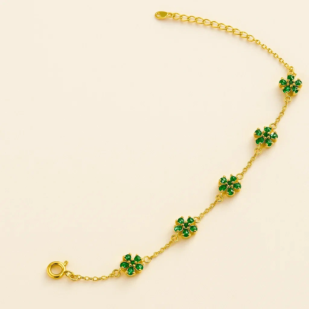 Three color variations of a 925 sterling silver flower chain bracelet: silver with clear stones, gold-plated with green stones, and gold-plated with pink stones.