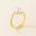 Gold ring with a pearl on a beige background