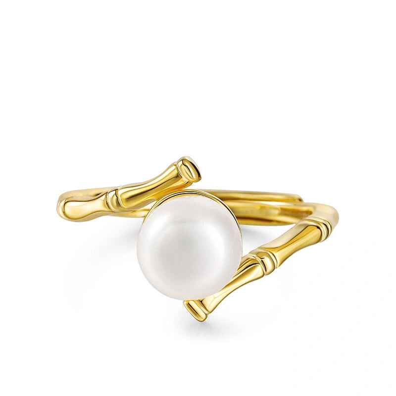 Gold ring with a pearl on a white background