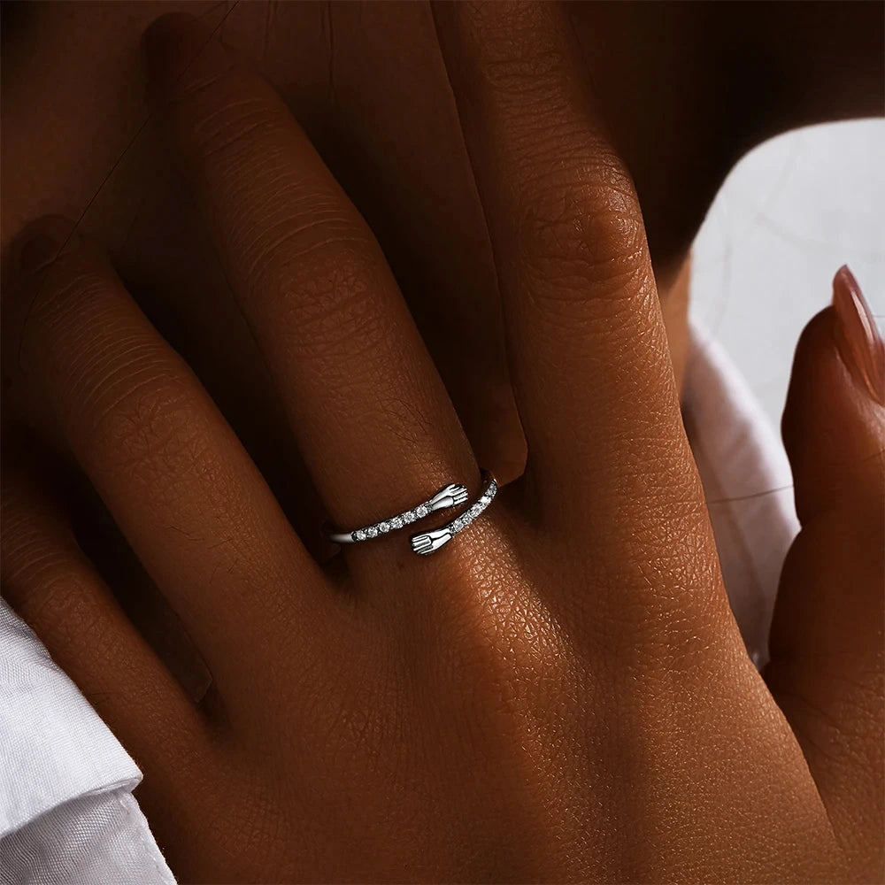 Silver ring on a person's finger with a blurred background