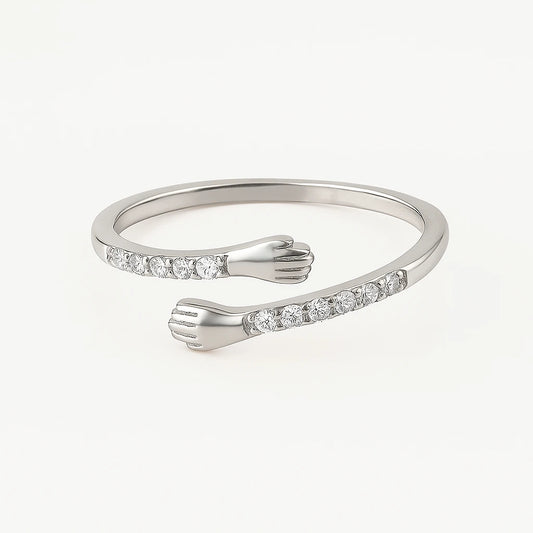 Adjustable 925‑silver embrace ring with cubic zirconia end stones on white background