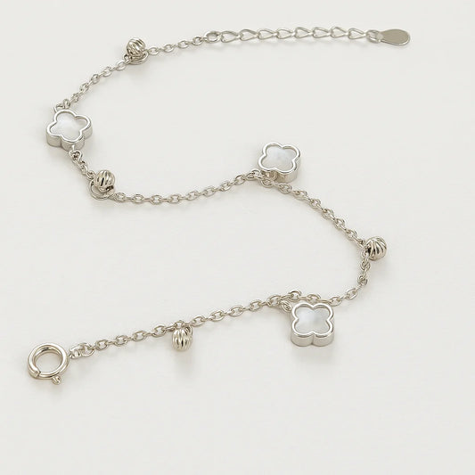 A beautiful gold-plated sterling silver bracelet featuring multiple mother-of-pearl clover charms and polished beads.