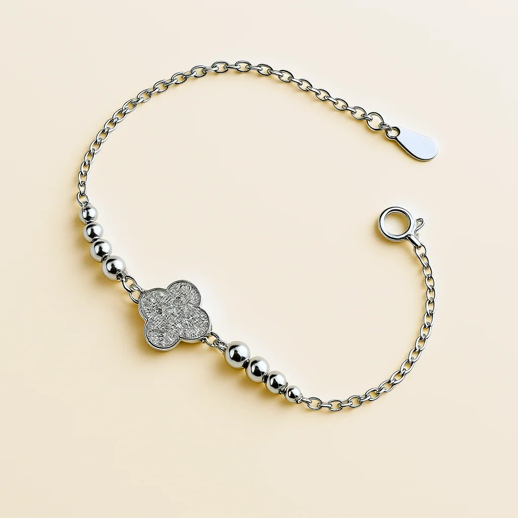 A beautiful gold-plated sterling silver bracelet featuring a four-leaf clover charm adorned with sparkling cubic zirconia stones.