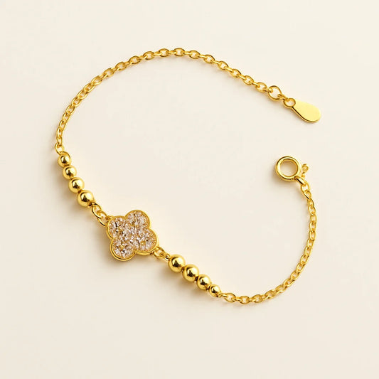 A beautiful gold-plated sterling silver bracelet featuring a four-leaf clover charm adorned with sparkling cubic zirconia stones.