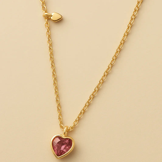 A 925 sterling silver and a gold-plated necklace, each with a heart-shaped stone pendant in pink or magenta.