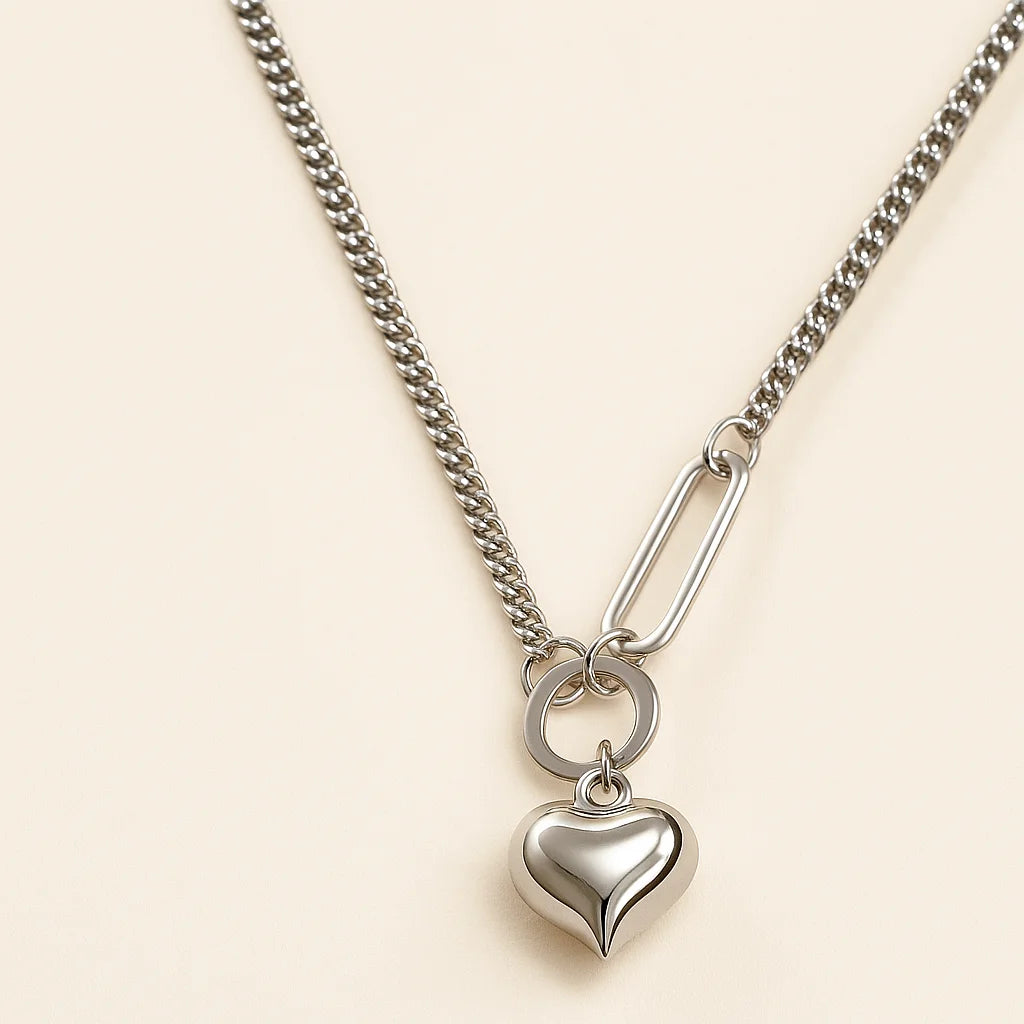 A 925 sterling silver and a gold-plated necklace, each with a smooth, polished heart-shaped pendant on a modern mixed-link chain.
