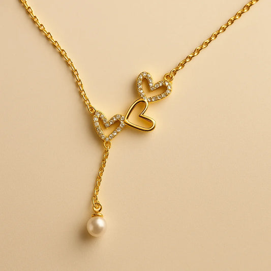 A 925 sterling silver and a gold-plated necklace, each with two intertwined hearts and a hanging pearl charm.