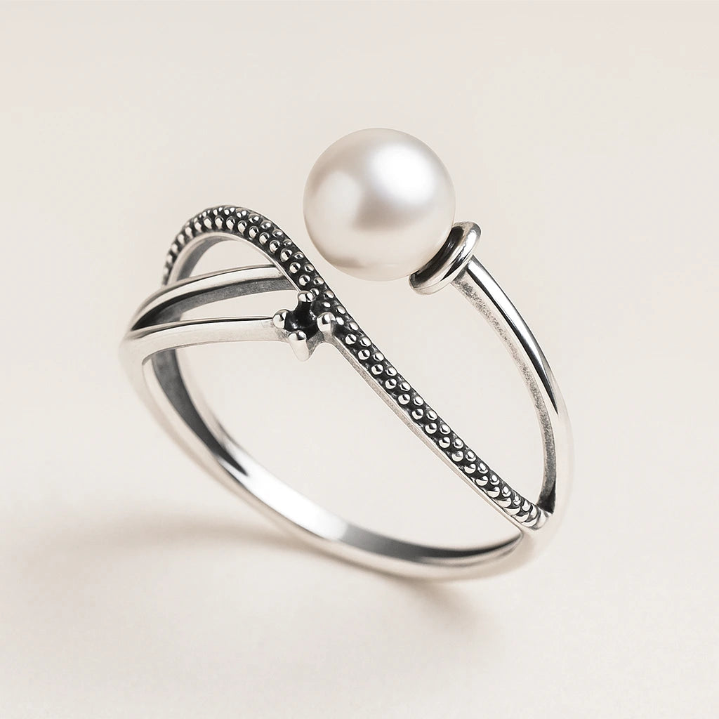 Silver Ring with a pearl on a light beige background