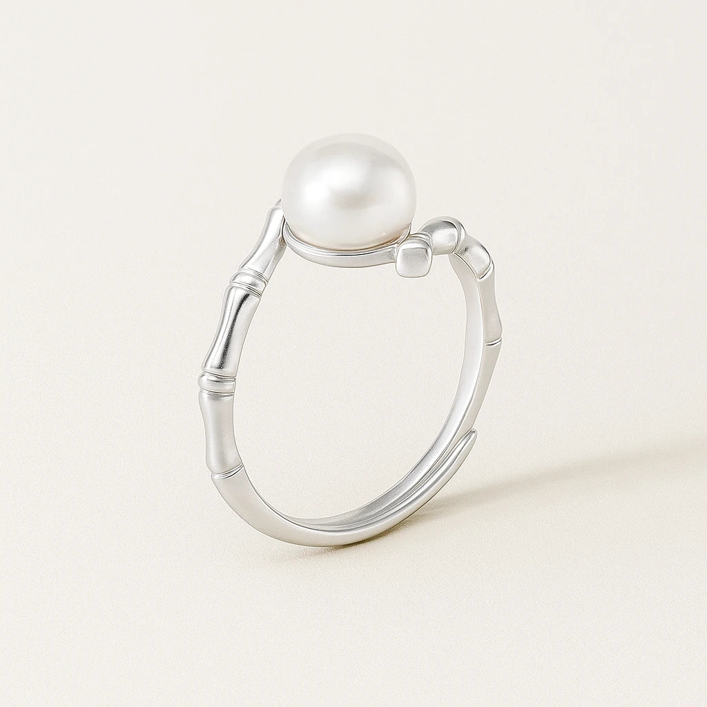 Silver ring with a pearl on a light background