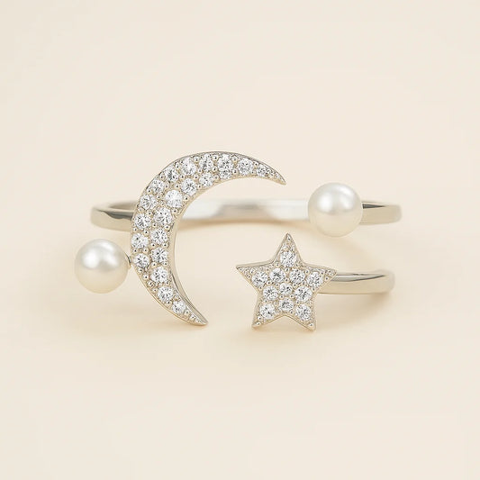 A 925 sterling silver open ring with a crescent moon, star, and faux pearls, all accented with cubic zirconia stones.