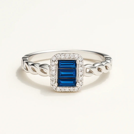A 925 sterling silver ring with a central blue rectangle-shaped stone, a sparkling halo, and a twisted band.