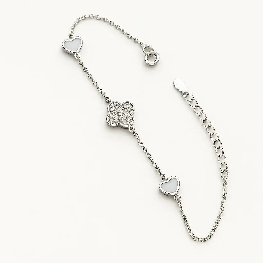 gold-plated sterling silver bracelet with heart charms and pavé four-leaf clover centerpiece.