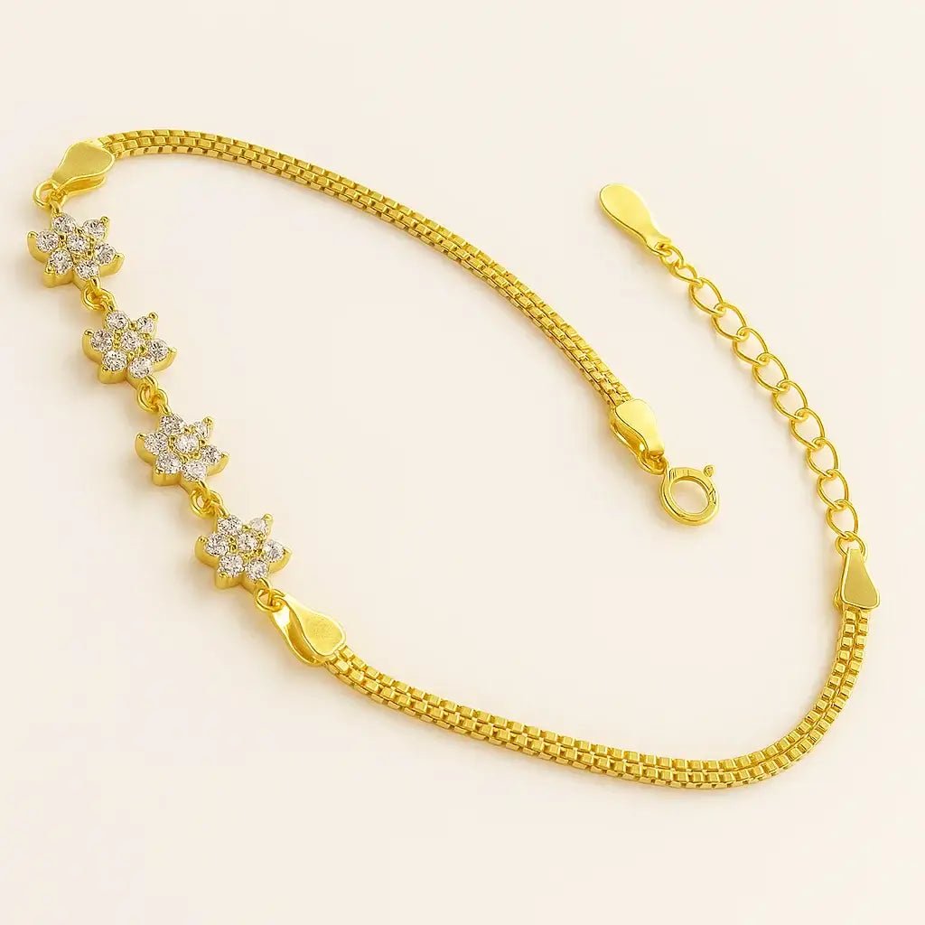 gold-plated sterling silver bracelet featuring flower-shaped links and sparkling cubic zirconia stones