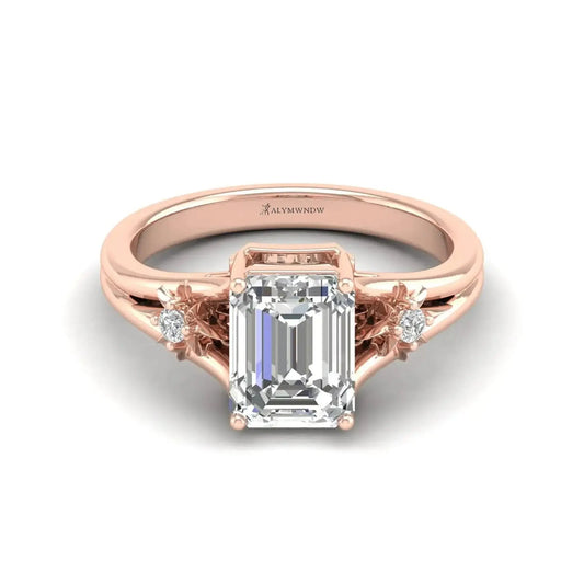 lab grown diamond engagement ring featuring an emerald cut center stone in rose gold setting.