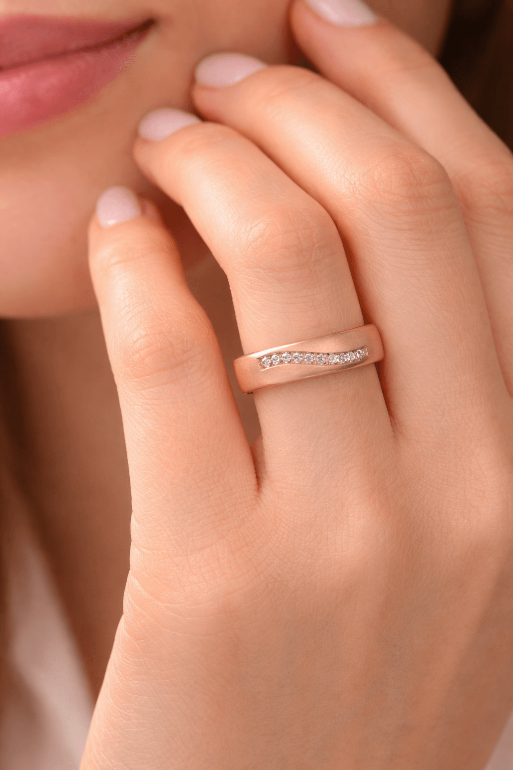 Luxury wedding rings showcased on a hand, featuring elegant design and sparkling details.