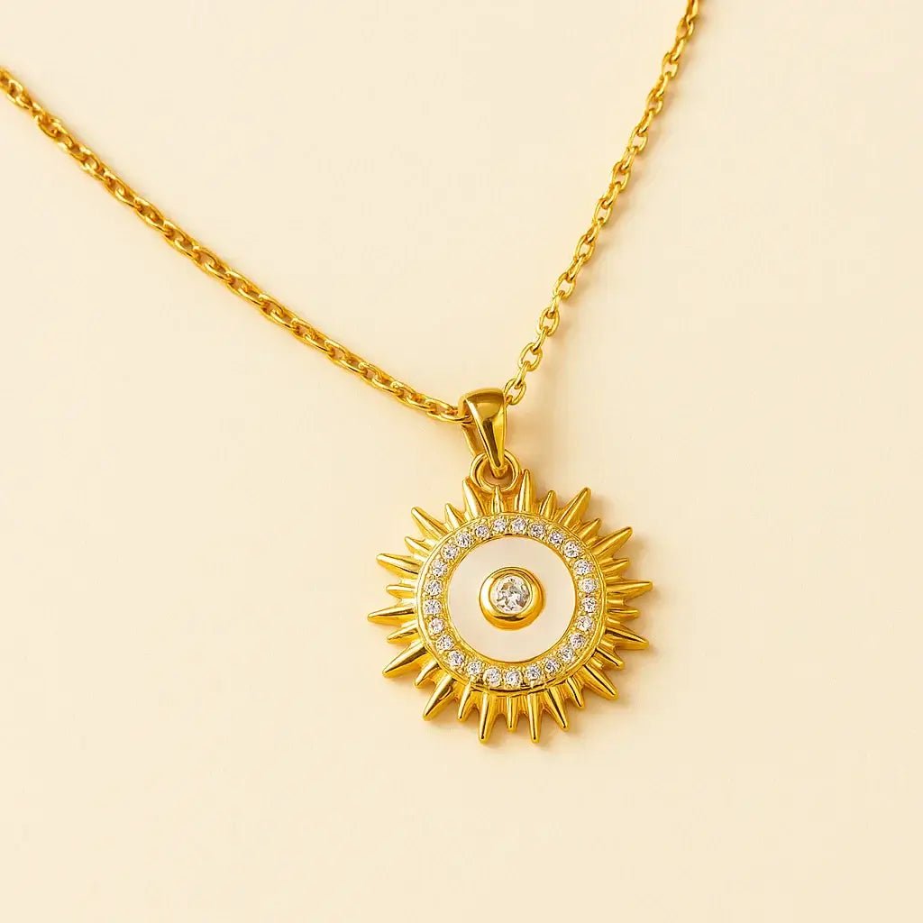 Solstice Gold-Plated Sunburst Necklace featuring a radiant sunburst pendant with cubic zirconia accents.